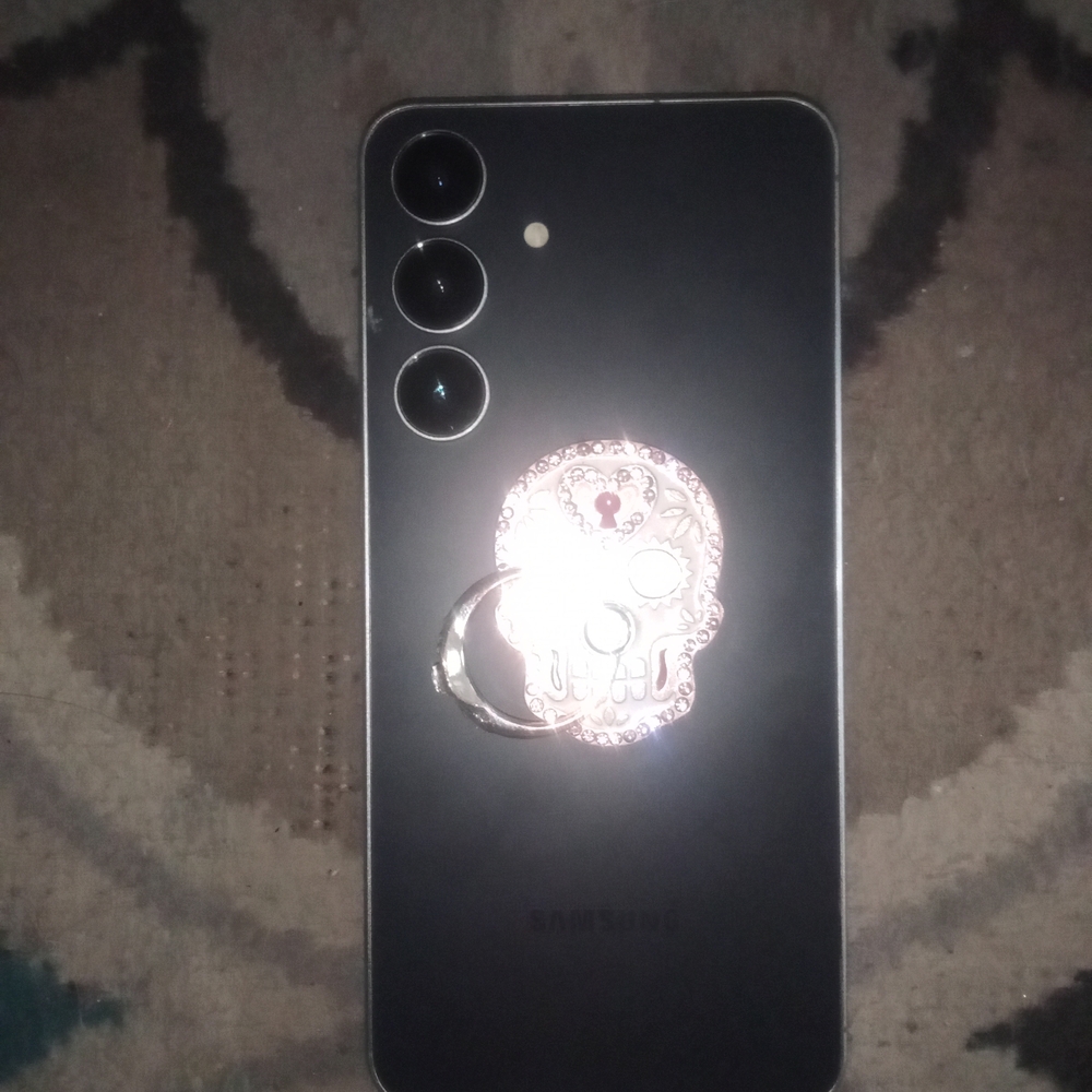 Samsung Black Phone with Silver Skull Keychain